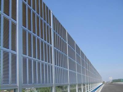 Aluminum sound barrier is installed between the highway and residential areas.