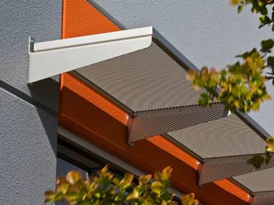A perforated sunshade panel is installed above the door horizontally.