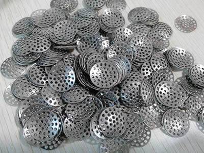 The picture shows many pieces of bowl-shape perforated filter bowl.