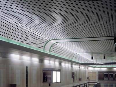 A perforated metal ceiling in the subway station.