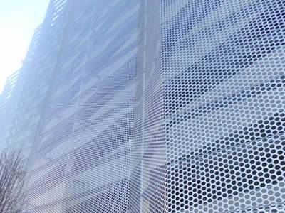 Perforated metal facade is covering the whole building.