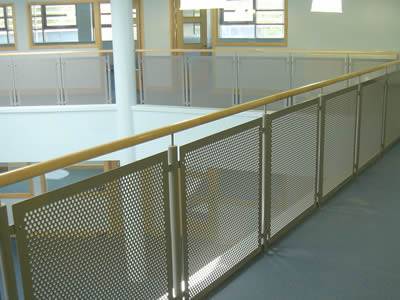 There are several perforated metal infill balustrades installing on the edge of the aisle outside the classrooms.