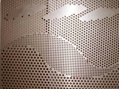 There is a pattern of leaf shape formed by small holes in the copper perforated plate.