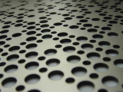 There are some holes of different sizes in the perforated metal plate.