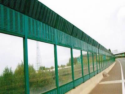 Perforated PVC sound barrier combines with polycarbonate sound barrier for highway.