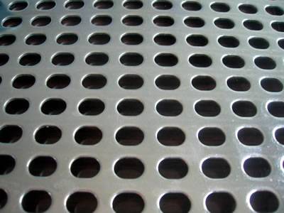 There is a perforated sheet with some oval holes in straight lines.