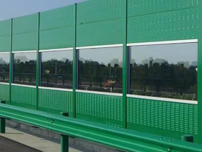 Top and bottom parts are green PVC sound barrier and middle part is polycarbonate sound barrier.