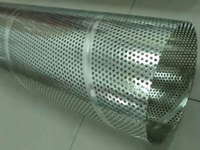 A aluminum spiral lock seam perforated tube on the floor.
