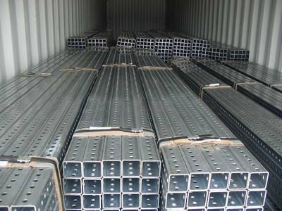 Steel square perforated pipes for road sign posts with steel strip packaged in container.